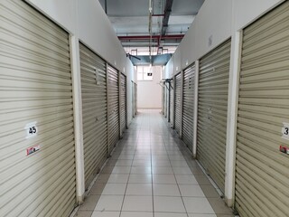 Symmetrical Hallway of Empty Self Storage Units with Closed Metal Doors