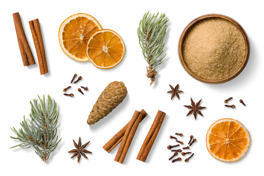 Set of traditional mulled wine or vin brule spices including dried orange slices, cinnamon sticks, anise, cloves and a wooden bowl filled with brown sugar, isolated on transparent background. 