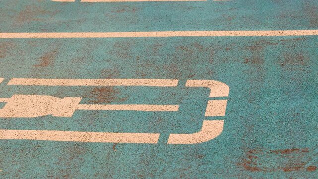 Electric charging sign painted on parking spot for electric vehicles alternative energy concept