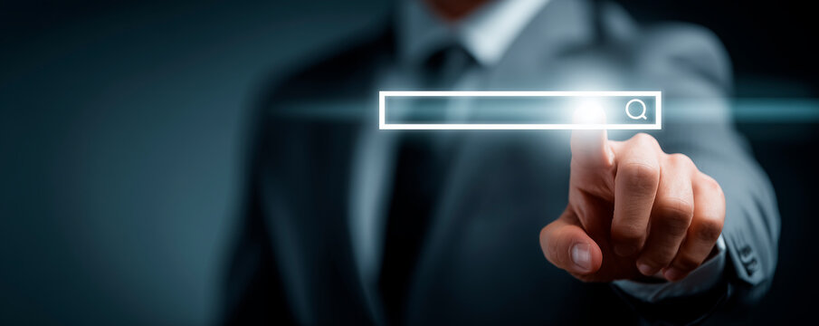Businessman in Suit Touches Virtual Search Bar with URL Link Indicating Online Presence and Digital Navigation in a Modern Technology Contex