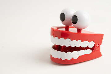 Funny red teeth with eye toy denture model for dental health care.