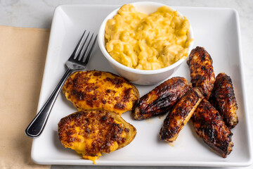 chicken wings with potato skins and mac and cheese