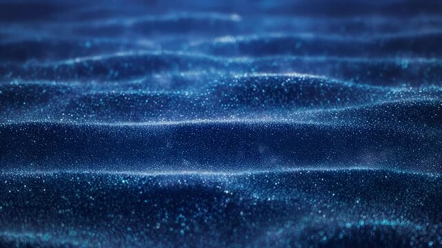 Abstract dark blue waves made of tiny shimmering particles, bokeh effect