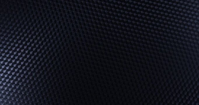 Carbon Texture Seamless Loop. Macro view of carbon weave with subtle metallic sheen gently shifting in a high-tech repeating pattern.