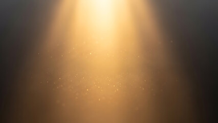 Golden light beam shining down with sparkling particles