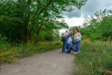 Father and children have fun, laugh and enjoy nature outdoors.