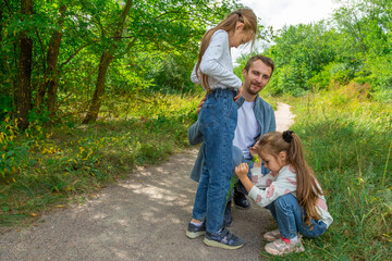 Fototapeta premium Father and children have fun, laugh and enjoy nature outdoors.