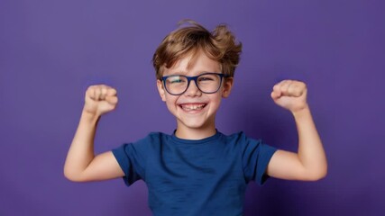 Video A young boy wearing glasses enthusiastically raises his arms in the air, conveying joy and enthusiasm