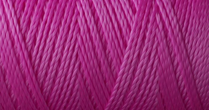 Pink Thread Macro Seamless Loop. Extreme close-up of bright pink sewing thread strands gently moving and catching light in a hypnotic repeating pattern.