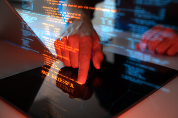 A close-up of a hackers hand interacting with glowing code on a laptop screen, showing blockchain information, and the message Hack Successful symbolizing cybersecurity breach and cybercrime