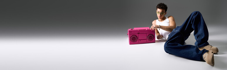 Stylish teenager with curly hair enjoys music in a trendy setting