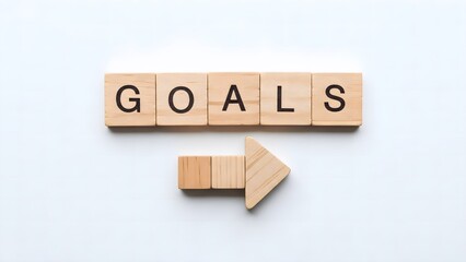 Goals Word with Wooden Blocks and Direction Arrow on White Background.