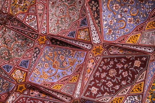 View of intricate geometric patterns and vibrant floral designs adorn the ceiling with contrasting colors creating an enchanting visual tapestry, Lahore, Punjab, Pakistan.