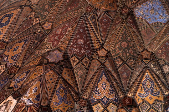 View of an intricately designed ceiling showcasing a complex array of geometric patterns and vibrant colors, creating a mesmerizing visual tapestry, Lahore, Punjab, Pakistan. - Powered by Adobe