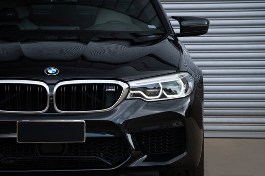 Black BMW M5 front grille and headlight close up, Luxury performance car detail with DRL on