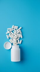 Clean Pharmaceutical Concept with Spilled White Capsules on Blue Surface - Top View Ecommerce Image