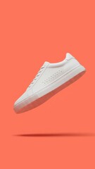 Clean and Dynamic Isolated White Sneaker Floating in Vibrant Coral Background