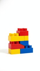 Obraz premium Vibrant Toy Building Blocks Tower on White Background with Playground Lighting - Photorealistic 8k Image in Primary Colors