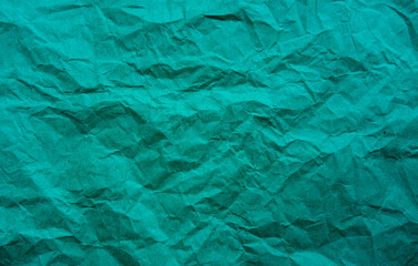 Minimal teal crumpled paper background with subtle folds and modern abstract texture