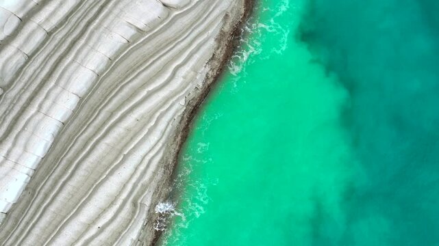 Scala dei Turchi, or the Turkish stairs in Sicily, Italy. Aerial Drone Shot. Unique White Rocks and Turquoise water.