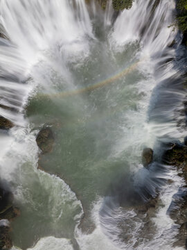 Aerial view of the cascading Quy Xuan river waterfall, its foamy waters swirling with a hint of rainbow iridescence, S&ocirc;ng Quy Xuan, Cao Bang, Vietnam.
