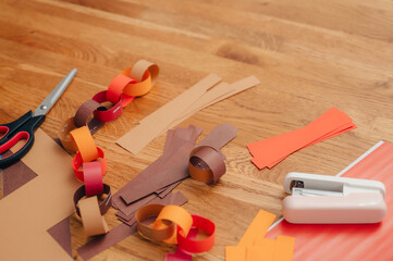 Overhead view of hands cutting colored paper with scissors, symbolizing creativity, crafting, and DIY projects