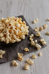 Homemade Salty Popcorn in a Bowl, side view.
