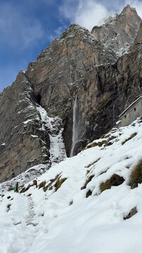 Vasudhara Falls near Badrinath in winter, surrounded by snow 4k.