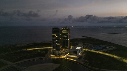 Aerial view of the Eko Atlantic City's skyline glows against the dark horizon, a modern marvel on the edge of the Atlantic, Lagos, Lagos, Nigeria.
