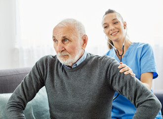 Doctor or nurse caregiver with senior man at home or nursing home