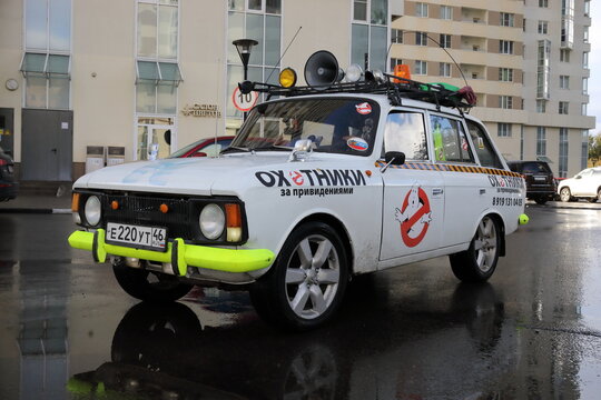 MOSCOW - OCT 04, 2018: A white car with a green bumper and license plate. Text on car - ghostbusters in the courtyard of the house in residential complex