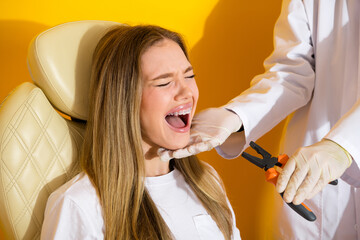Young woman in dental chair with braces smiling during checkup as dentist presents tools against...