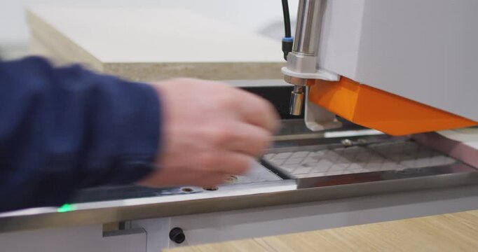 Industrial woodworking machine processing a furniture board