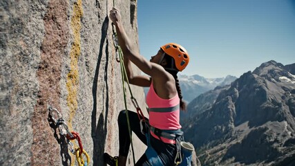 Woman Rock Climbing on Mountain Side With Safety Equipment