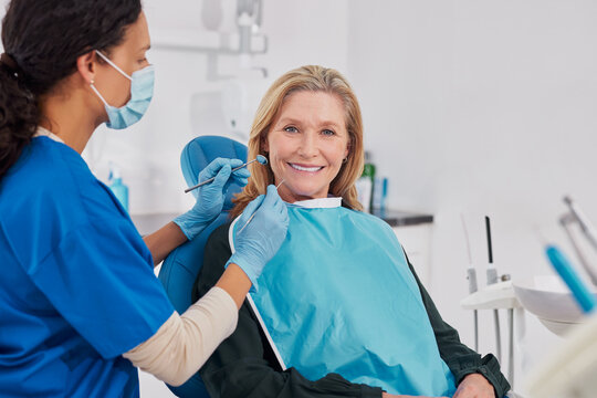 Smiling old woman looking at camera at dental clinic