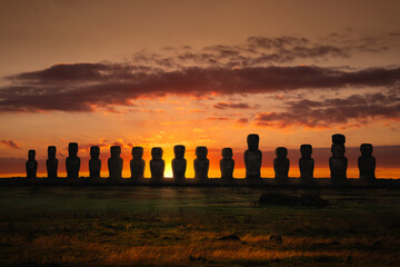 Silhouettes of the 15 moai statues at Ahu Tongariki on Rapa Nui (Easter Island), Chile, against a...