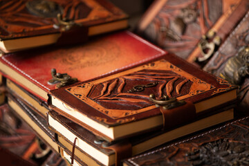 Handcrafted leather journals displayed in an artistic arrangement showcasing intricate designs and...