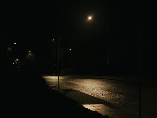 Dark Empty Road at Night with Single Street Light, Minimal Urban Scene and Moody Atmosphere