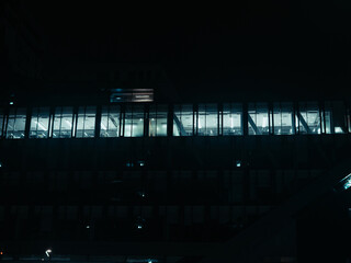 Modern Office Building Windows at Night with Interior Lights, Dark Urban Architecture and Minimal Corporate Atmosphere