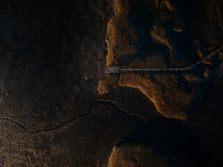 Aerial view of golden light kissing the rugged coastline and pier, revealing the tranquil beauty of the Gloucester shore, Gloucester, Massachusetts, United States.