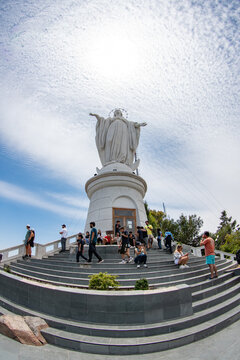 Santiago, Chile - 07 December 2024: View of the Immaculate Conception statue atop San Cristobal Hill, with its white marble contrasting against the vibrant blue sky and gathering crowds.