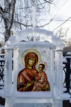 View of a frozen ice sculpture of the Virgin Mary holding baby Jesus stands as a testament of faith amidst the winter landscape, Irkutsk, Irkutsk Oblast, Russia.