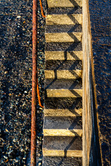 Geometric concrete steps with strong angular shadows and rusted metal detail