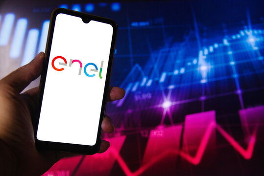 Enel logo on a smartphone screen with a stock chart in the background. An Italian multinational company that plays an important role in energy distribution and generation in Brazil.