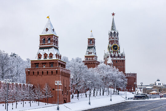 View of the red-bricked Kremlin towers standing majestically amidst a winter wonderland, dusted with snow, showcasing Russia's architectural heritage, Moscow, Moscow, Russia.