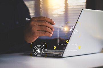 Businessman planning overall goals and direction of the strategy. Project Roadmap Concept. Digital interface on computer with roadmap overlay representing steps in project strategic planning process.