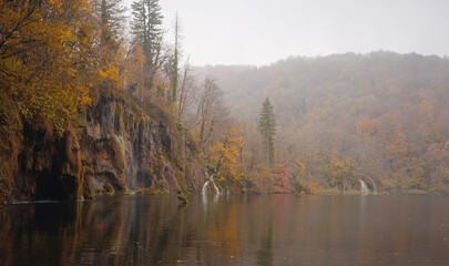 Plitvice Lakes in Croatia during autumn, showcasing stunning waterfalls, vibrant foliage, and crystal-clear waters, creating a magical and serene natural landscape perfect for nature lovers.