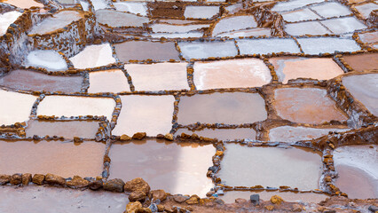 Maras, Cusco, Per&uacute;, Peru: panoramic view of traditional Andean salt ponds forming geometric patterns in the Sacred Valley. The mineral-rich basins display natural colors and textured surfaces.