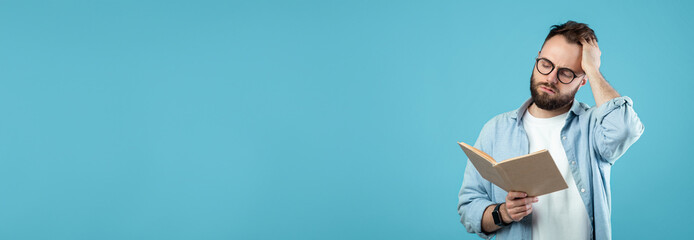 A man stands with a book in hand, appearing deep in thought. He has glasses and a beard, wearing a casual shirt. The background is a solid light blue, creating a calm atmosphere.