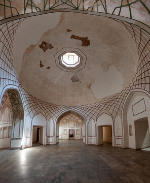 View of a grand hall featuring a high, domed ceiling adorned with intricate geometric patterns and an octagonal skylight, Lahore, Punjab, Pakistan.